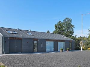 a building with solar panels on top of it at 9 person holiday home in Dannemare in Dannemare