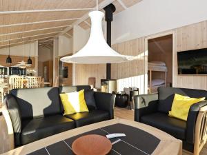 a living room with a couch and a table at Luxury Retreat in Lonstrup - By Traum Ferienwohnungen in Hjørring