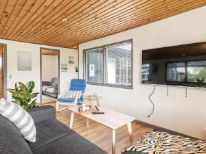 a living room with a couch and a tv at Holiday home in Sæby near beach in Sæby +29 photos