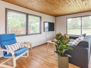a living room with a couch and a tv at Holiday home in Sæby near beach in Sæby
