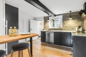 a kitchen with a wooden table and a counter at TV1654-Albaek-Hovej-3 in Ålbæk