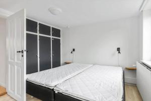 a white bedroom with a large bed in it at TV1654-Albaek-Hovej-3 in Ålbæk