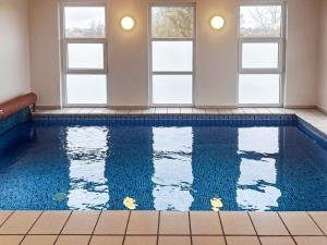 a swimming pool in a room with windows at Luxury Retreat in Hejlsminde - By Traum in Hejls