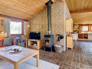 a living room with a brick fireplace in a house at 6 person holiday home in Blokhus-By Traum in Blokhus