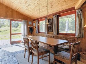 a dining room with a wooden table and chairs at 6 person holiday home in Blokhus-By Traum in Blokhus +38 photos