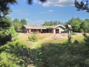 a house in the middle of a field at 6 person holiday home in Blokhus-By Traum in Blokhus