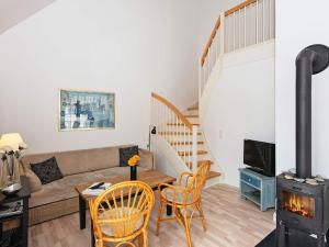 a living room with a couch and a wood stove at 6 person holiday home in Ringkøbing in Ringkøbing