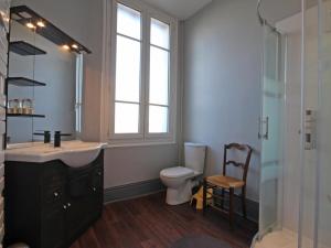 a bathroom with a sink and a toilet and a window at Maison de maître 19ème, parc arboré et cheminée, centre L'Aigle - FR-1-497-57 in LʼAigle +17 photos