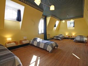 a large room with two beds and two windows at Maison de maître 19ème, parc arboré et cheminée, centre L'Aigle - FR-1-497-57 in LʼAigle