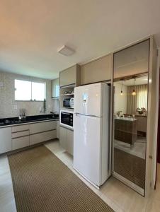 a kitchen with a white refrigerator and a sink at Apto completo cop 30 in Belém