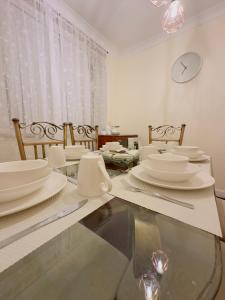 a dining room with a table with white dishes on it at Harbour Haven North Shields Family & Work Stays in North Shields