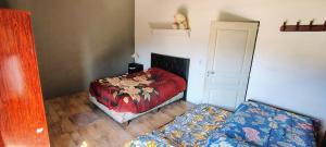 a bedroom with a bed and a couch in it at El rancho de la familia in Tristán Suárez