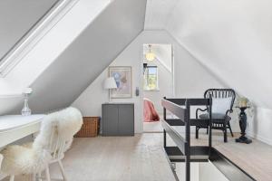 a room with a table and chairs in a attic at TV1673-Bindslev-Noddevaenget-1 in Bindslev