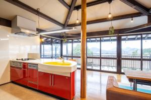 a kitchen with a sink and a large window at Izu Ricca - Vacation STAY 83345 in Izunokuni