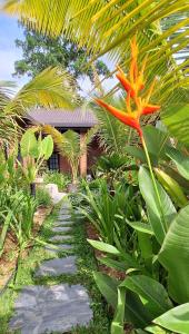 a orange flower is growing in a garden at Lot2990 Seremban 3 Homestay by SkyLimit Suites in Seremban