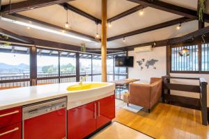 a kitchen with a sink and a living room at Izu Ricca - Vacation STAY 83345 in Izunokuni