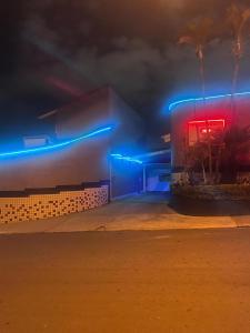 a building with blue and red lights on it at POUSADAS CLUB Dmais1 in Sorocaba