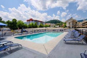 a swimming pool with lounge chairs and a hotel at The Gillette in Gatlinburg