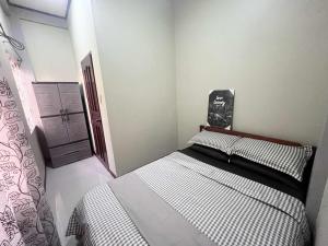 a bedroom with two beds and a chalkboard on the wall at Ace Transient in Puerto Princesa City