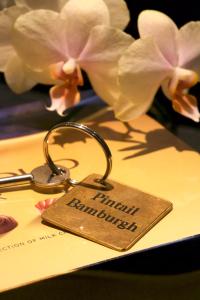 a pair of keys sitting on top of a menu at Pintail Apartment Bamburgh in Bamburgh
