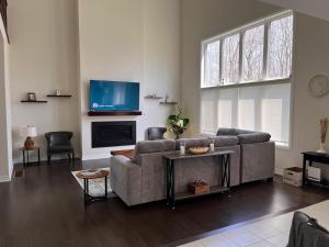 a living room with a couch and a tv at Severn Woodland in Severn