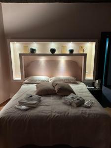 a bedroom with a large bed with towels on it at HDSM Accomodation in Monteforte Irpino