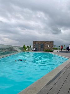 a swimming pool with a person in the water at Loxwood House Luxury Apartment in Accra