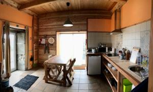 a kitchen with a table and a counter top at Casa Malagueta in Lajes das Flores