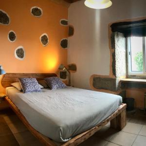 a bedroom with a bed in a room with a window at Casa Malagueta in Lajes das Flores