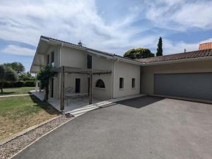 a white house with a garage at Maison avec jardin clos et piscine privée - FR-1-653-279 in Soyaux