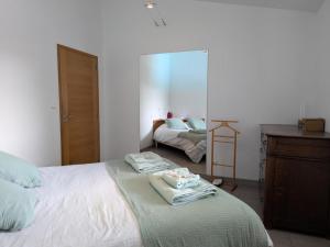 a bedroom with a bed with folded towels on it at Maison avec jardin clos et piscine privée - FR-1-653-279 in Soyaux +24 photos