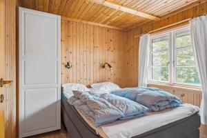 a bed sitting in a room with a window at K19047-Kalundborg-Charlesvej-8 in Kalundborg
