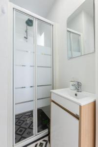 a bathroom with a shower and a sink at Beach House - Terrace sea sunset in Labruge