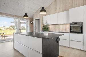 a kitchen with white cabinets and a black counter top at SL296-Slagelse-Athenesvej-7 in Slagelse