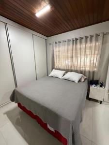 a bedroom with a large bed in a room at CASA COP 30 - Conjunto Marex - A poucos metros do Hangar e do Aeroporto de Belém in Belém
