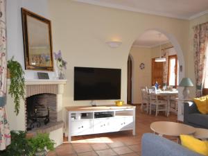 a living room with a television and a fireplace at Family Villa with Valley Views in Rojales