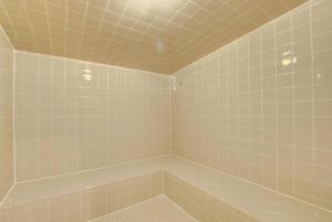 a bathroom with a tiled shower with a tub at One Bedroom In Lux Condo,casa Costa! Wbeachpass! in Boynton Beach +20 photos