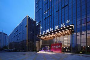 a building with a sign in front of it at Grand Madison Hotel Hangzhou in Hangzhou
