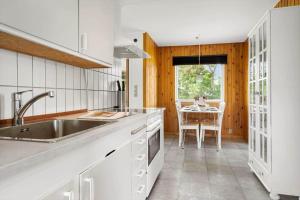 a kitchen with a sink and a table at 20221-Samso-Violvej-8 in Tanderup +24 photos