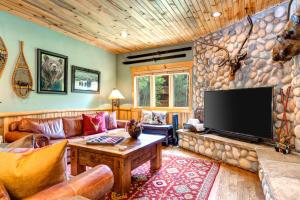 a living room with a large flat screen tv at KBM Resorts Timber Wolf Lodge Walk to Canyons Cabriolet Fireplace BBQ Aspens Creek Parking TWL-12c in Park City