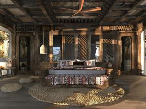 a living room with a ceiling fan and a table at HaGiang Go Ecolodge in Làng Lap