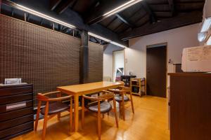 a dining room with a wooden table and chairs at SHINJUKU Garden-house in Tokyo