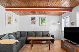 a living room with a couch and a table at 20203-Samso-Vrangstrup-5 in Tanderup