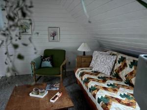 a living room with a couch and a chair at 20203-Samso-Vrangstrup-5 in Tanderup