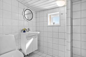 a white bathroom with a sink and a mirror at 20203-Samso-Vrangstrup-5 in Tanderup +20 photos