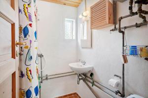 a bathroom with a sink and a shower curtain at 20601-Samso-Nordby-Hovedgade-2 in Nordby +26 photos