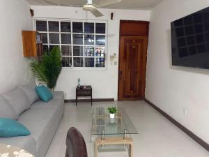 a living room with a couch and a glass table at Departamento completo bien ubicado in Minatitlán +4 photos