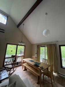 a living room with a wooden table and chairs at Luxury Mountain Getaway - 6 bed, 3 bath, hot-tub, fire-pit, game-room in Hunter