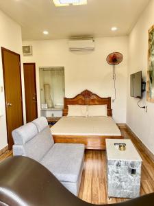 a living room with a bed and a couch at Duy Anh Hotel Biên Hoà in Bien Hoa +40 photos