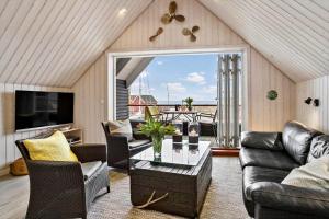 a living room with a couch and a table at 20123-Samso-Maarup-Havn-7-A in Nordby